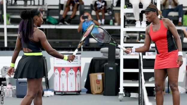 Serena Williams (left) touches racquets with sister Venus (right) after their last-16 tie at the Top Seed Open in Kentucky