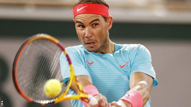 Rafael Nadal returns against Stefano Travaglia