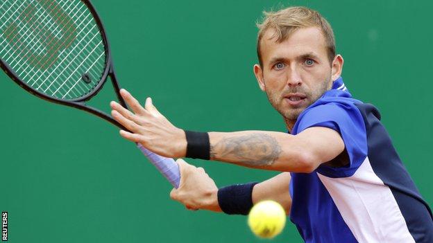 Dan Evans hits a return against Stefanos Tsitsipas