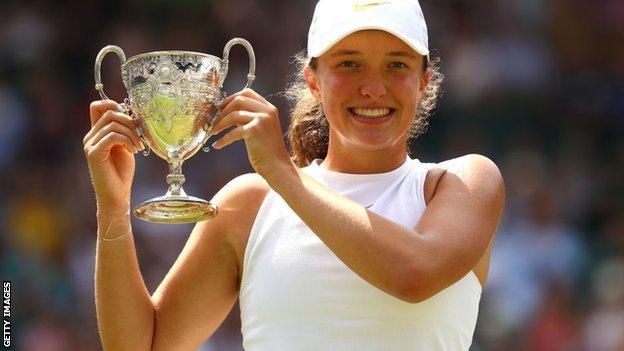 Iga swiatek with the 2018 junior wimbledon trophy