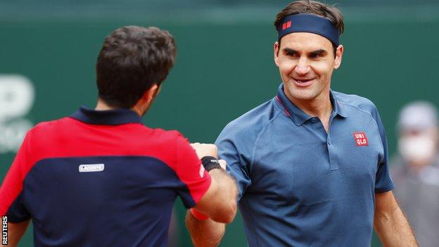 Roger Federer shakes hands with Pablo Andujar at the net after their match in Geneva